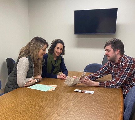A group of employees discussing in a meeting